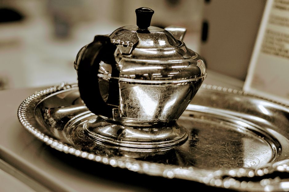 Silver 1 A stylish vintage silver teapot elegantly placed on a matching ornate serving tray, capturing timeless sophistication.